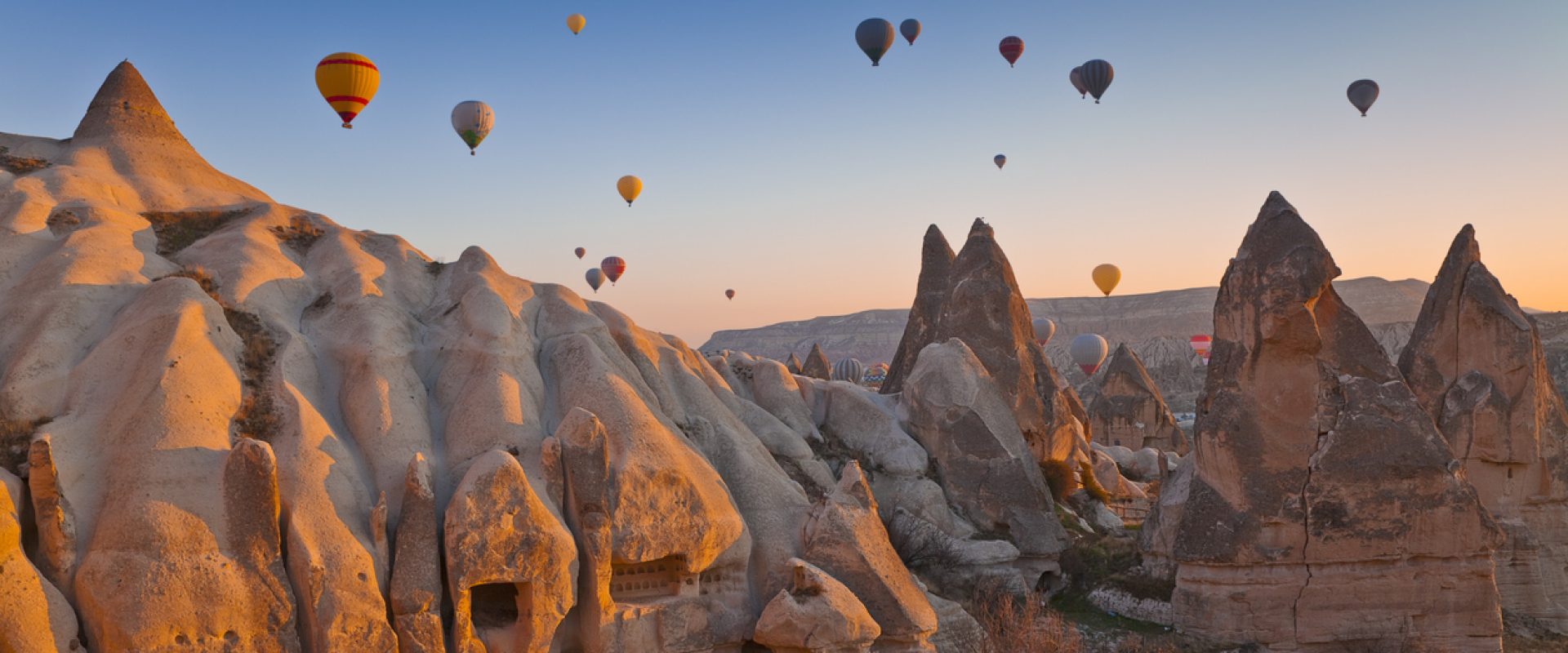 Hot Air Balloons rise up over the Goreme Valley in Cappadocia, Turkey